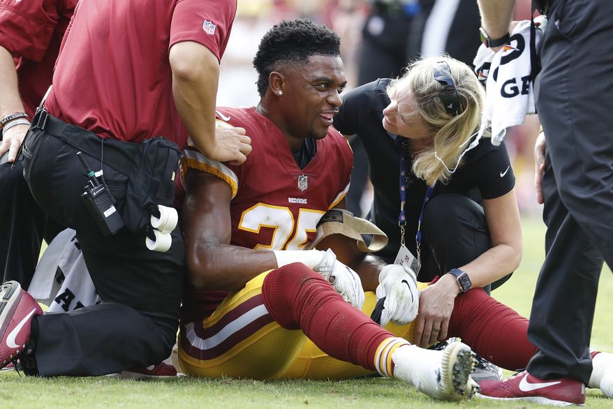 FILE - In this Oct. 15, 2017, file photo, trainers tend to Washington Redskins strong safety Montae Nicholson (35) after and injury during the first half of an NFL football game against the San Francisco 49ers, in Landover, Md. Nicholson was arrested early Tuesday morning, Dec. 18, 2018, and charged with assault and battery and being drunk in public from a fight at a restaurant and retail complex near the team’s practice facility in Ashburn, Virginia. (AP Photo/Alex Brandon) ** FILE **