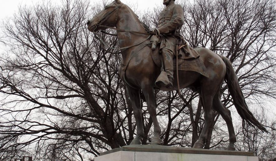 FILE - In this Feb. 6, 2013, file photo, a statue of Nathan Bedford Forrest sits on a concrete pedestal at a park named after the confederate cavalryman in Memphis Tenn. Descendants of Nathan Bedford Forrest are claiming that the graves of the Confederate general and his wife were desecrated when the statue of him was removed from a Tennessee park last year. Forrest’s great-great-grandsons filed a lawsuit in a Memphis court Monday, Dec. 17, 2018, seeking damages and possession of the statue after it was taken down in December 2017. (AP Photo/Adrian Sainz, File)
