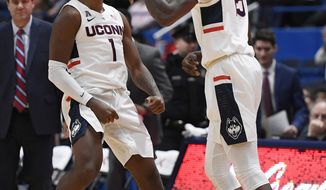 Connecticut&#39;s Christian Vital (1) and Connecticut&#39;s Sidney Wilson (15) react during the first half of an NCAA college basketball game against Drexel, Tuesday, Dec. 18, 2018, in Hartford, Conn. (AP Photo/Jessica Hill)