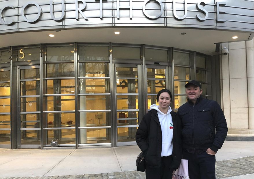 In this Dec. 3, 2018 photo, Australian tourists Wayne Burg and his daughter Lydia stand in front of Brooklyn's federal courthouse in New York, where they were viewing the trial of Mexican drug trafficker Joaquin "El Chapo" Guzman. Burg is a criminal lawyer in his home country and said he did not want to miss the chance to witness one day in the trial of "El Chapo." (AP Photo/Claudia Torrens)