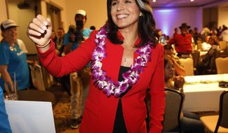 File - In this Nov. 6, 2018, file photo, Rep. Tulsi Gabbard, D-Hawaii, greets supporters in Honolulu. Gabbard, a Democratic congresswoman, is eyeing a White House run. The Iraq war veteran has visited New Hampshire and Iowa in recent months and has written a memoir that’s due to be published in May. First elected to the state Legislature at age 21, Gabbard throughout her career has ignored suggestions that she wait her turn. (AP Photo/Marco Garcia, File)
