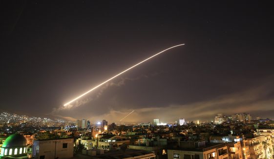 The Damascus sky lights up missile fire as the U.S. launches an attack on Syria targeting different parts of the capital early Saturday, April 14, 2018. (AP Photo/Hassan Ammar)