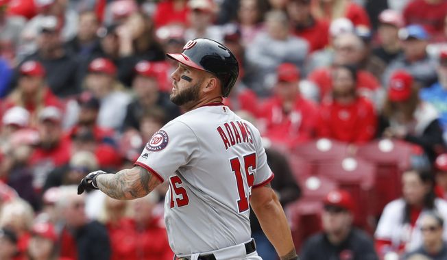 FILE - In this March 31, 2018, file photo, Washington Nationals' Matt Adams hits a three-run home run off Cincinnati Reds starting pitcher Luis Castillo in the first inning of a baseball game, n Cincinnati. The Nationals have agreed to terms a $4 million, one-year deal with first baseman Matt Adams that includes a mutual option for 2020. General manager Mike Rizzo announced the contract Tuesday, Dec. 18, 2018. He fills a void for Washington as a left-handed bat who is expected to split time at first base with Ryan Zimmerman. (AP Photo/John Minchillo, File) **FILE**
