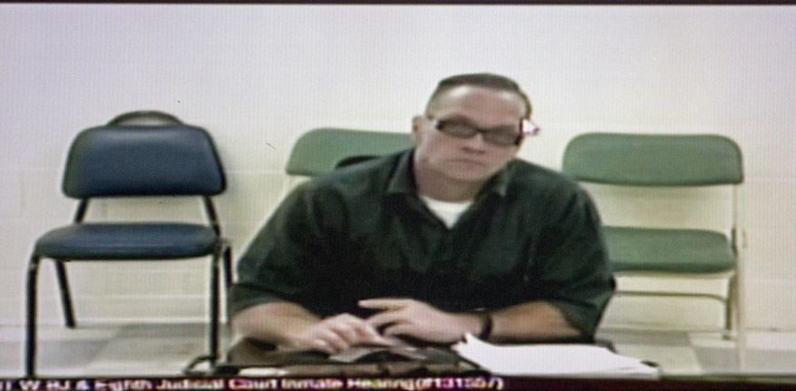 FILE - In this Dec. 5, 2017, file photo, Nevada death row inmate Scott Dozier appears for his court hearing via video at the Regional Justice Center in Las Vegas. Nevada prison officials say death row inmate Dozier has gone to great lengths to try to kill himself while awaiting execution, including attempting to obtain a fatal drop of a deadly drug on a piece of paper sent through prison mail. (Erik Verduzco/Las Vegas Review-Journal via AP)
