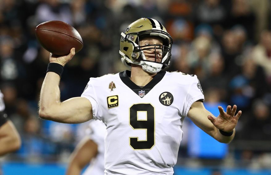 FILE - In this Dec. 17, 2018 file photo New Orleans Saints' Drew Brees (9) looks to pass against the Carolina Panthers in the first half of an NFL football game in Charlotte, N.C. Brees is the starting quarterback for the NFC backed by Green Bay’s Aaron Rodgers and the Rams’ Jared Goff for the Pro Bowl which will be played Jan. 27 in Orlando. (AP Photo/Jason E. Miczek, file)