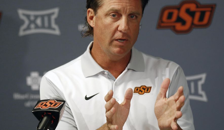 FILE - In this Aug. 24, 2018, file photo, Oklahoma State head coach Mike Gundy talks with the media during an NCAA college football news conference in Stillwater, Okla. College football recruiting fans used to treat the first Wednesday of February like a virtual national holiday. Now that date’s been pushed into the background, likely for good.“I just think everybody sees (December) as the new signing date, in my opinion,” Oklahoma State coach Mike Gundy said. (AP Photo/Sue Ogrocki, File)