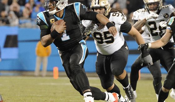 Carolina Panthers&#39; Cam Newton (1) scrambles past New Orleans Saints&#39; Tyeler Davison (95) in the first half of an NFL football game in Charlotte, N.C., Monday, Dec. 17, 2018. (AP Photo/Mike McCarn)