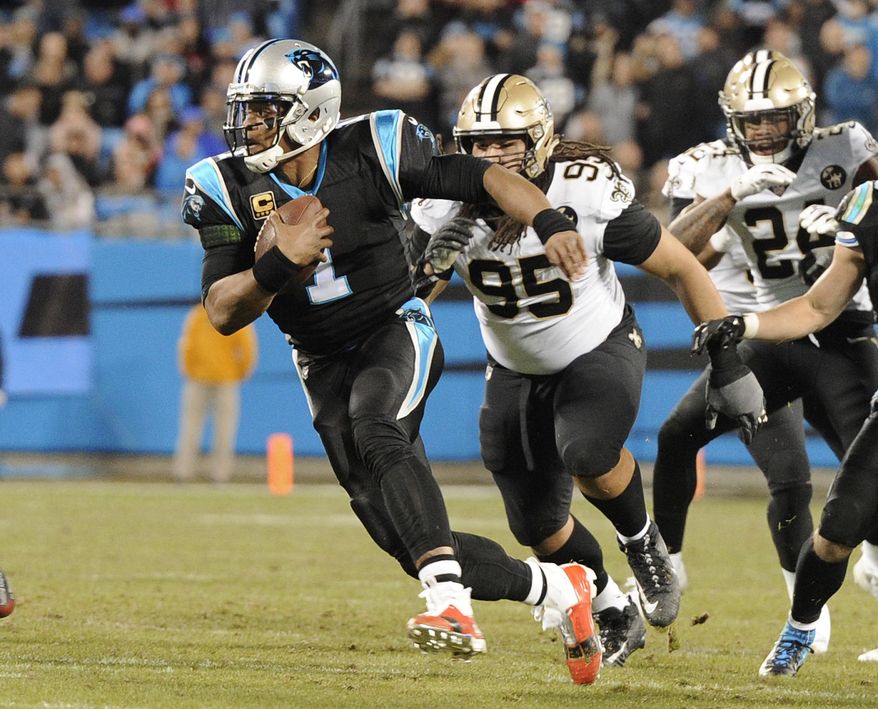 Carolina Panthers&#39; Cam Newton (1) scrambles past New Orleans Saints&#39; Tyeler Davison (95) in the first half of an NFL football game in Charlotte, N.C., Monday, Dec. 17, 2018. (AP Photo/Mike McCarn)
