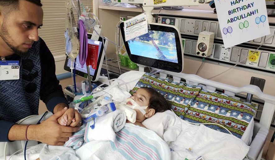 This recent but undated photo, released Monday, Dec. 17, 2018 by the Council on American-Islamic Relations in Sacramento, Calif., shows Ali Hassan with his dying 2-year-old son Abdullah in a Sacramento hospital. The boy&#x27;s Yemeni mother, blocked by the Trump administration&#x27;s travel ban, has won her fight for a waiver that would allow her to travel to California to see her son. Basim Elkarra of the Council on American-Islamic Relations in Sacramento said Shaima Swileh was granted a visa Tuesday, Dec. 18, 2018, and will be flying to San Francisco on Wednesday, Dec. 19, 2018. (Council on American-Islamic Relations via AP)