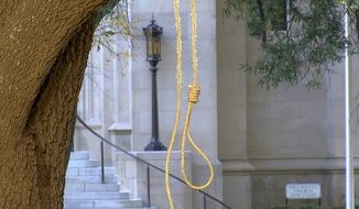 In this photo provided by WLBT-TV a noose hangs on a tree on the state capitol grounds in Jackson, Miss. on Monday, Nov. 26, 2018. A Mississippi official says two nooses and six signs were found on the grounds of the Mississippi state Capitol. Chuck McIntosh, a spokesman for the Mississippi Department of Finance and Administration, which oversees the Capitol, says the nooses and signs were found Monday morning between 7:30 a.m. and 8 a.m. (WLBT-TV via AP)