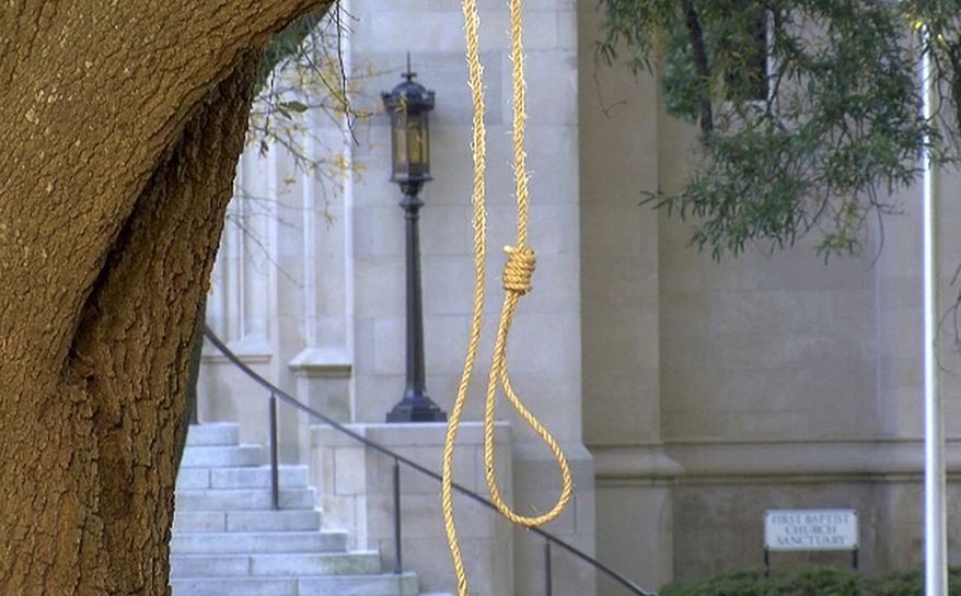 In this photo provided by WLBT-TV a noose hangs on a tree on the state capitol grounds in Jackson, Miss. on Monday, Nov. 26, 2018. A Mississippi official says two nooses and six signs were found on the grounds of the Mississippi state Capitol. Chuck McIntosh, a spokesman for the Mississippi Department of Finance and Administration, which oversees the Capitol, says the nooses and signs were found Monday morning between 7:30 a.m. and 8 a.m. (WLBT-TV via AP)