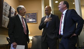 Sen. Cory Booker, D-N.J., center, talks with Sen. Chuck Grassley, R-Iowa, left, and Sen. Mike Lee, R-Utah, right, before they participate in a news conference on Capitol Hill in Washington, Wednesday, Dec. 19, 2018, on prison reform legislation. A criminal justice bill passed in the Senate gives judges more discretion when sentencing some drug offenders and boosts prisoner rehabilitation efforts. (AP Photo/Susan Walsh)