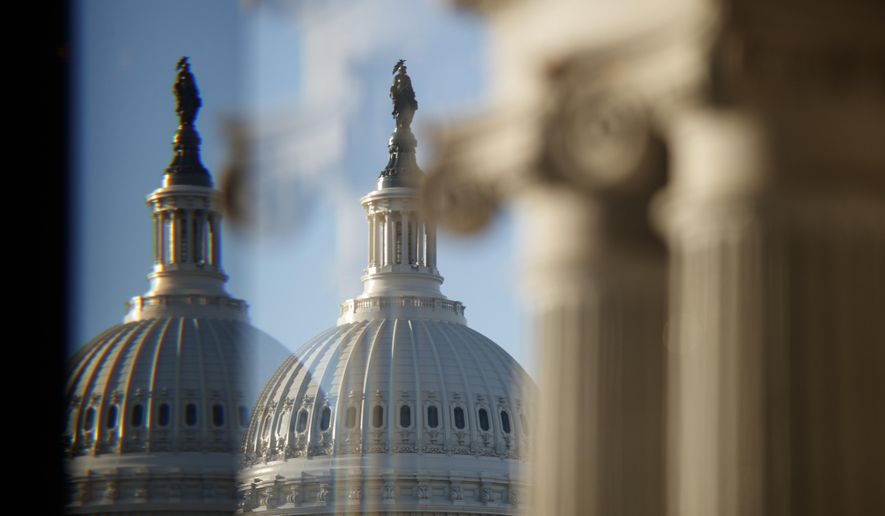 The U.S. Capitol Building Dome is seen through a beveled window at the Library of Congress in Washington, Wednesday, Dec. 19, 2018. (AP Photo/Carolyn Kaster)