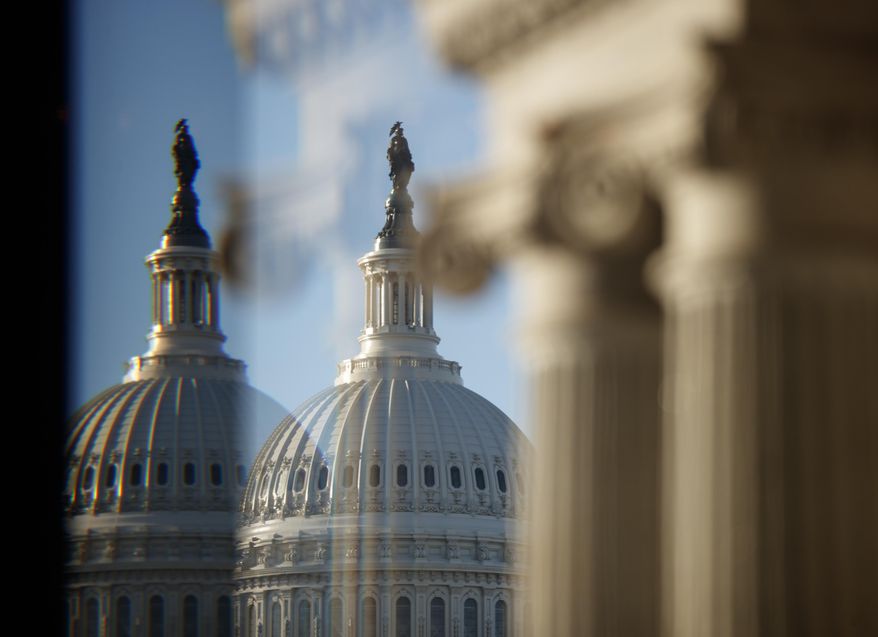 The U.S. Capitol Building Dome is seen through a beveled window at the Library of Congress in Washington, Wednesday, Dec. 19, 2018. (AP Photo/Carolyn Kaster)