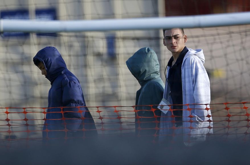 Migrant teens walk inside the Tornillo detention camp in Tornillo, Texas, Thursday, Dec. 13, 2018. The Trump administration announced in June 2018 that it would open the temporary shelter for up to 360 migrant children in this isolated corner of the Texas desert. Six months later, the facility has expanded into a detention camp holding thousands of teenagers. (AP Photo/Andres Leighton)