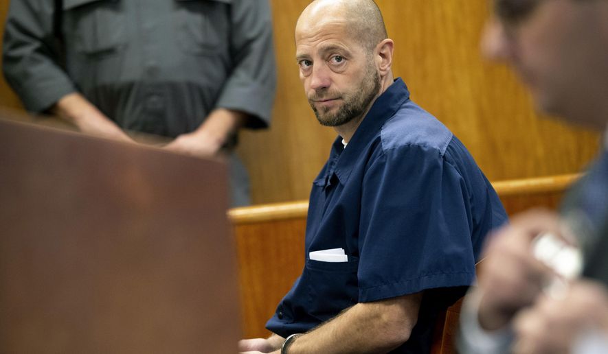 In this Dec. 14, 2018 photo, Christopher Machacek looks to Assistant Washtenaw County Prosecutor Michael Doby as he pleads his case for resentencing at Washtenaw County Trial Court in Ann Arbor, Mich. Machacek, who was 16 when he killed 13-year-old Mary Ann Hulbert in Michigan, was resentenced to 37-60 years in prison for the Dec. 30, 1986 shooting death of Hulbert. She had told Machacek she might be pregnant with his child. (Jacob Hamilton/Ann Arbor News via AP)