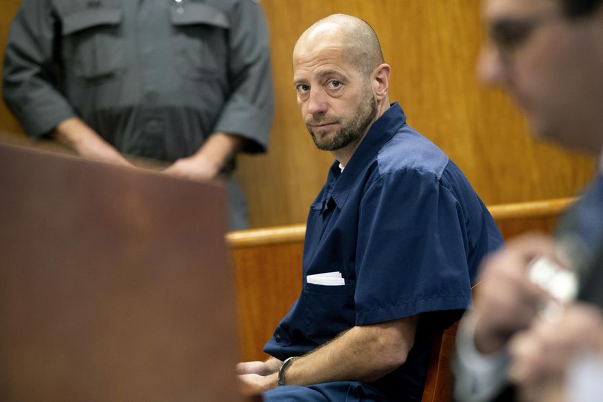 In this Dec. 14, 2018 photo, Christopher Machacek looks to Assistant Washtenaw County Prosecutor Michael Doby as he pleads his case for resentencing at Washtenaw County Trial Court in Ann Arbor, Mich. Machacek, who was 16 when he killed 13-year-old Mary Ann Hulbert in Michigan, was resentenced to 37-60 years in prison for the Dec. 30, 1986 shooting death of Hulbert. She had told Machacek she might be pregnant with his child. (Jacob Hamilton/Ann Arbor News via AP)