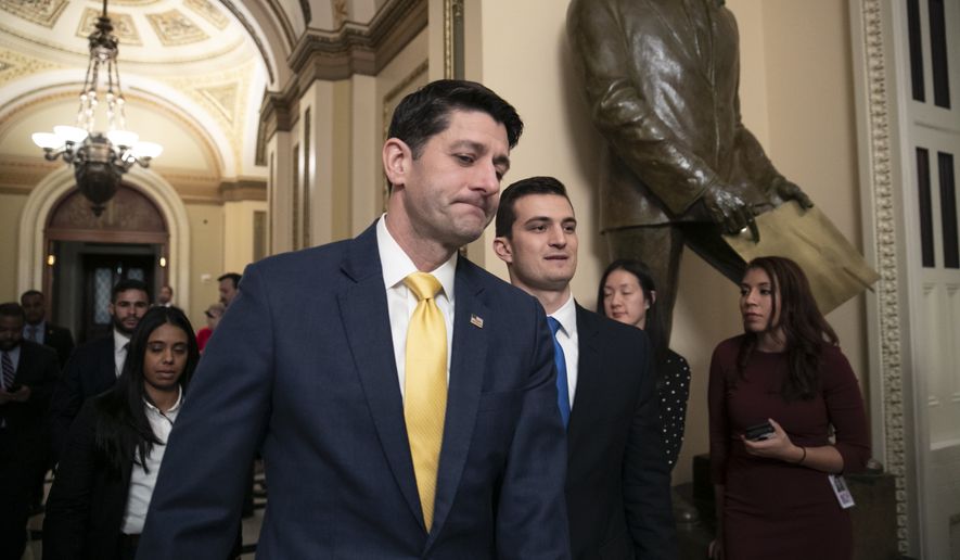 House Speaker Paul Ryan leaves the chamber as a revised spending bill is introduced that includes $5 billion demanded by President Donald Trump for a wall along the U.S.-Mexico border, as Congress tries to avert a partial shutdown, in Washington, Thursday, Dec. 20, 2018. (AP Photo/J. Scott Applewhite)