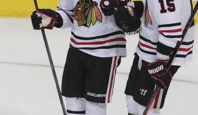 Chicago Blackhawks right wing Patrick Kane (88) celebrates his goal with center Artem Anisimov (15) during the third period of an NHL hockey game against the Dallas Stars in Dallas, Thursday, Dec. 20, 2018. The Blackhawks won 5-2. (AP Photo/LM Otero)