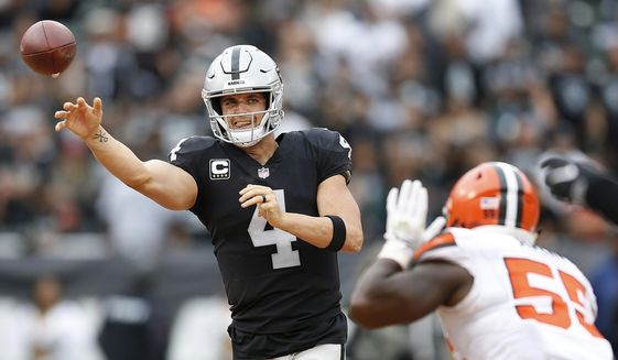 FILE - In this Sunday, Sept. 30, 2018, file photo, Oakland Raiders quarterback Derek Carr (4) passes against Cleveland Browns linebacker Genard Avery (55) during overtime of an NFL football game in Oakland, Calif. Carr is the first player in four years to get sacked at least three times in seven consecutive games but remains on pace for his first career 4,000-yard season. (AP Photo/D. Ross Cameron) ** FILE **