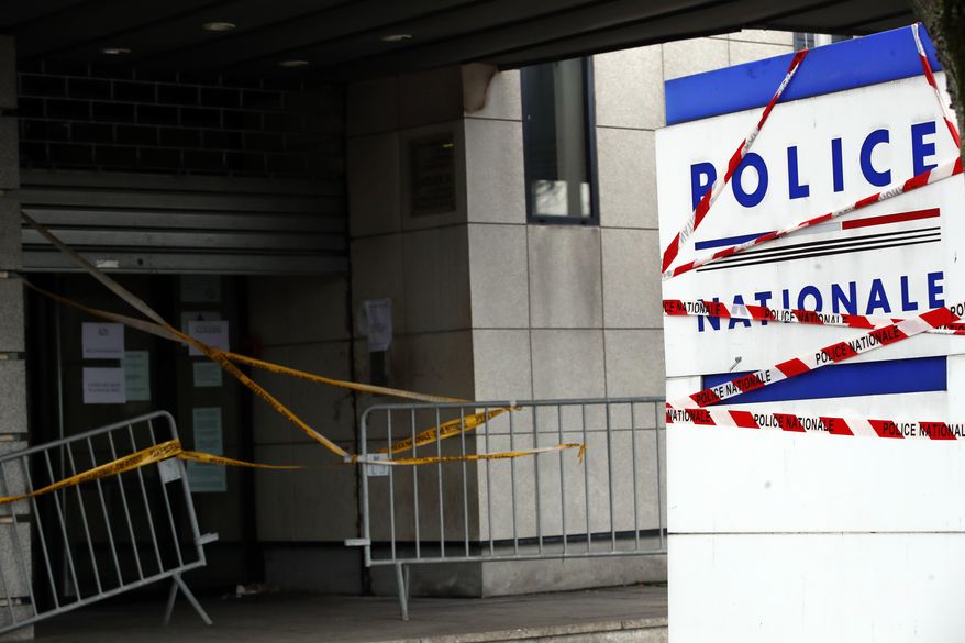 Stickers are set up in protest on the entrance of the police station in Mantes-la-Jolie, west of Paris, Wednesday, Dec. 19, 2018. French authorities are suggesting they will bow to demands by police officers for decades of overtime pay, but officers nevertheless engaged in go-slows Wednesday, including at France's biggest airport, seeking to ensure that the payback matches intentions. (AP Photo/Christophe Ena)