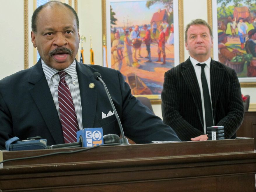 Carl Snowden speaks at a news conference to discuss a fundraising effort and plans for a contest to select a memorial concept to honor the five people who were killed in the Capital Gazette newspaper shooting this summer as Annapolis Mayor Gavin Buckley stands behind, Thursday, Dec. 20, 2018 in Annapolis, Md. (AP Photo/Brian Witte)