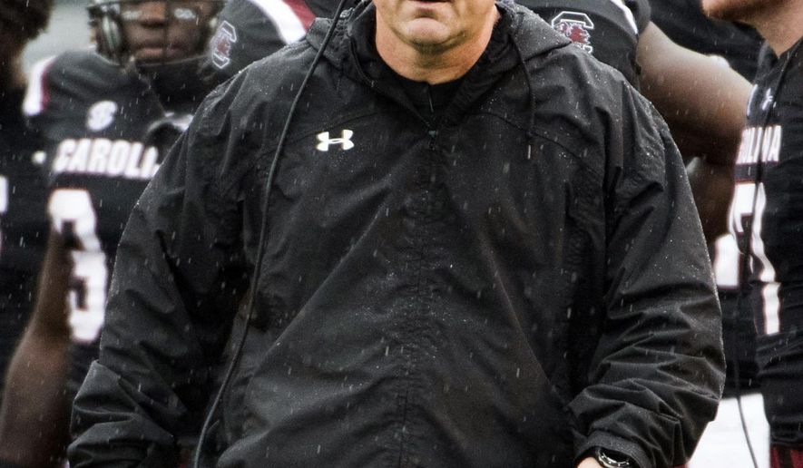 FILE - In this Dec. 1, 2018, file photo, South Carolina head coach Will Muschamp walks across the field during an NCAA college football game against Akron in Columbia, S.C. Muschamp's Gamecocks want to the have a strong finish to their season when they take on Virginia at the Belk Bowl next week. (AP Photo/Sean Rayford, File)