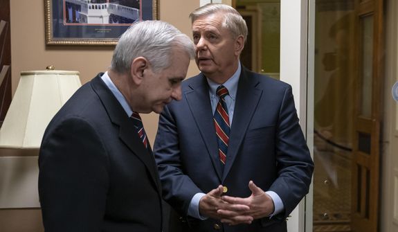 Sen. Jack Reed, D-R.I., left, and Sen. Lindsey Graham, R-S.C., members of the Senate Armed Services Committee, confer prior to a news conference to say they are disagreeing with President Donald Trump&#39;s sudden decision to pull all 2,000 U.S. troops out of Syria, at the Capitol in Washington, Thursday, Dec. 20, 2018. (AP Photo/J. Scott Applewhite)