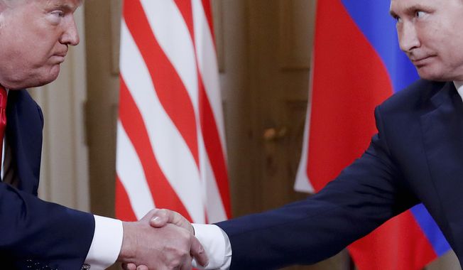 In this Monday, July 16, 2018, photo, U.S. President Donald Trump, left, and Russian President Vladimir Putin, right, shake hand at the beginning of a meeting at the Presidential Palace in Helsinki, Finland. Throughout 2018, special cnvestigator Robert Mueller’s team investigated whether Trump&#x27;s campaign colluded with Russia ahead of the 2016 election and whether the president obstructed the investigation. (AP Photo/Pablo Martinez Monsivais/File)