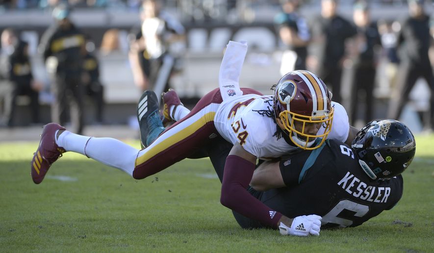 Jacksonville Jaguars quarterback Cody Kessler (6) is tackled by Washington Redskins cornerback Josh Norman (24) after scrambling for yardage during the second half of an NFL football game Sunday, Dec. 16, 2018, in Jacksonville, Fla. (AP Photo/Phelan M. Ebenhack) ** FILE **