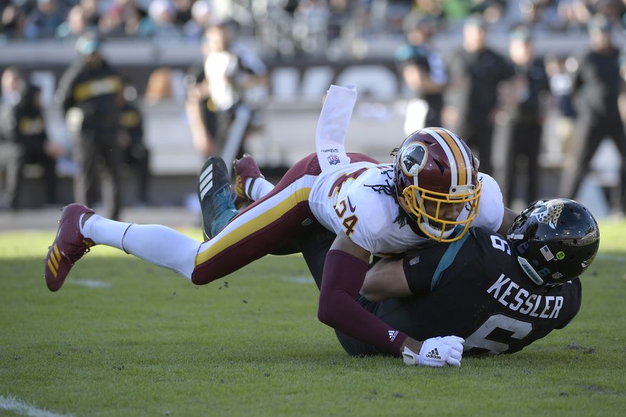 Jacksonville Jaguars quarterback Cody Kessler (6) is tackled by Washington Redskins cornerback Josh Norman (24) after scrambling for yardage during the second half of an NFL football game Sunday, Dec. 16, 2018, in Jacksonville, Fla. (AP Photo/Phelan M. Ebenhack) ** FILE **