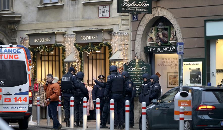 Police officers investigate a crime scene in Vienna, Austria, Friday, Dec. 21, 2018. A shooting Friday in central Vienna has killed one person and wounded another, Austrian authorities said. Police said on Twitter that two people with gunshot wounds were found at about 1:30 p.m. in the Lugeck square area in the Austrian capital. There was no immediate information on their identities. (AP Photo/Ronald Zak)