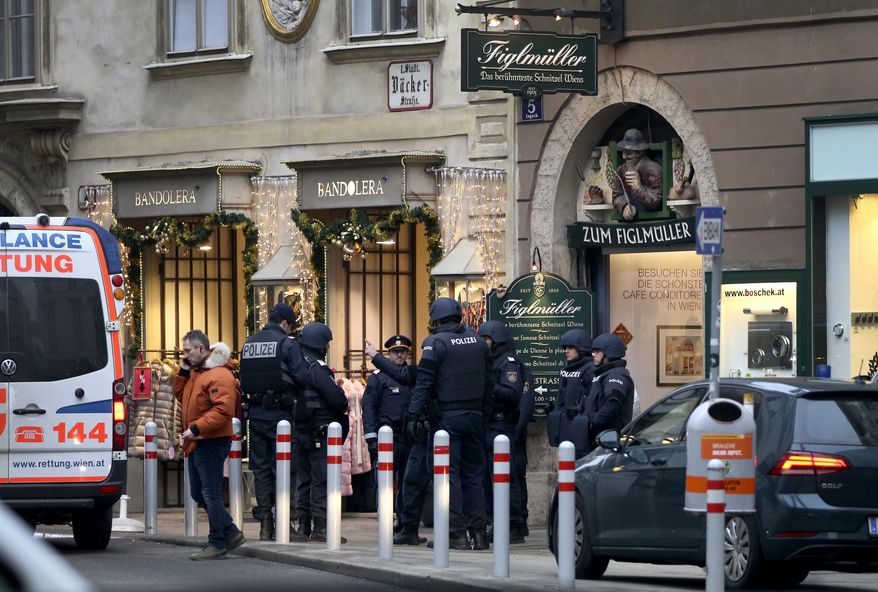 Police officers investigate a crime scene in Vienna, Austria, Friday, Dec. 21, 2018. A shooting Friday in central Vienna has killed one person and wounded another, Austrian authorities said. Police said on Twitter that two people with gunshot wounds were found at about 1:30 p.m. in the Lugeck square area in the Austrian capital. There was no immediate information on their identities. (AP Photo/Ronald Zak)