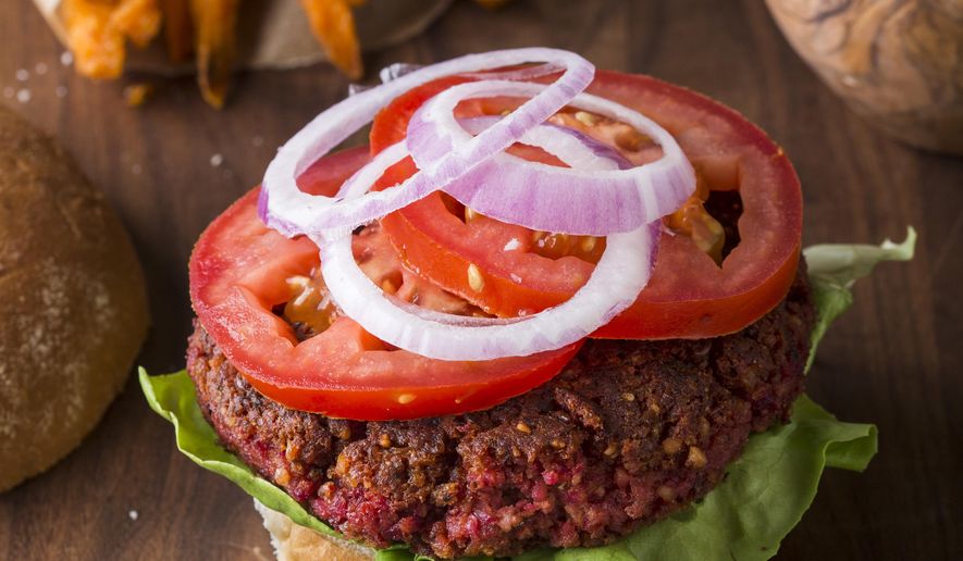 This undated photo provided by America's Test Kitchen in December 2018 shows Pinto Bean-Beet Burgers in Brookline, Mass. This recipe appears in the cookbook "Nutritious Delicious." (Joe Keller/America's Test Kitchen via AP)