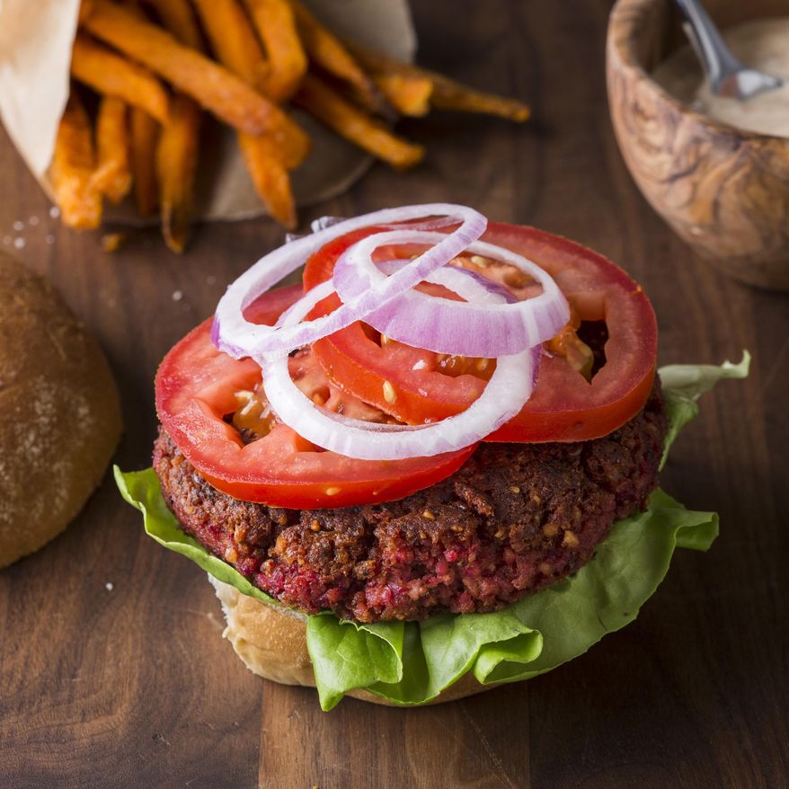 This undated photo provided by America's Test Kitchen in December 2018 shows Pinto Bean-Beet Burgers in Brookline, Mass. This recipe appears in the cookbook "Nutritious Delicious." (Joe Keller/America's Test Kitchen via AP)