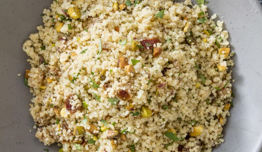 This undated photo provided by America's Test Kitchen in December 2018 shows Simple Couscous with Dates and Pistachios in Brookline, Mass. This recipe appears in the cookbook "Complete Mediterranean." (Daniel J. van Ackere/America's Test Kitchen via AP)