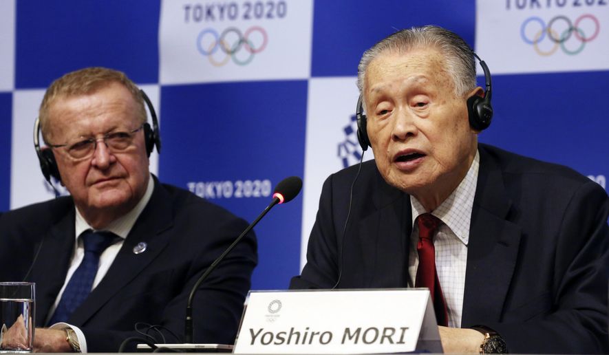 FILE - In this Dec. 5, 2018, file photo, Tokyo 2020 President Yoshiro Mori, right, speaks as IOC inspection team head John Coates listens during a press conference in Tokyo. Organizers of the 2020 Tokyo Olympics said Friday, Dec. 21, 2018, they picked up another $1 million in domestic sponsorships and that the operating budget for the games remains at $5.6 billion. (AP Photo/Koji Sasahara, File)