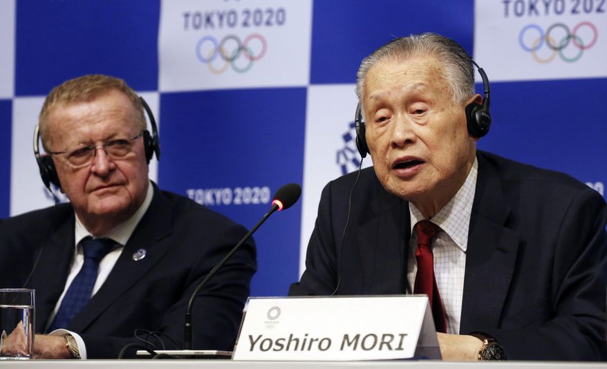 FILE - In this Dec. 5, 2018, file photo, Tokyo 2020 President Yoshiro Mori, right, speaks as IOC inspection team head John Coates listens during a press conference in Tokyo. Organizers of the 2020 Tokyo Olympics said Friday, Dec. 21, 2018, they picked up another $1 million in domestic sponsorships and that the operating budget for the games remains at $5.6 billion. (AP Photo/Koji Sasahara, File)