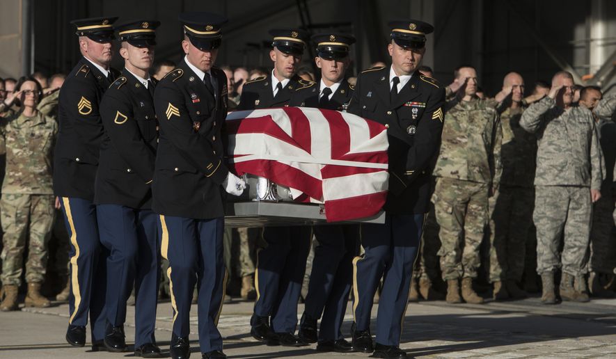 FILE - In this Nov. 14, 2018, file photo, Utah National Guard Honor Guard carry a casket containing the remains of Maj. Brent R. Taylor at the National Guard base, in Salt Lake City. The family of a Utah mayor killed while serving in the National Guard in Afghanistan will have one less financial worry this holiday season after a charity paid off their mortgage. (Matt Herp/Standard-Examiner, via, Pool, File)