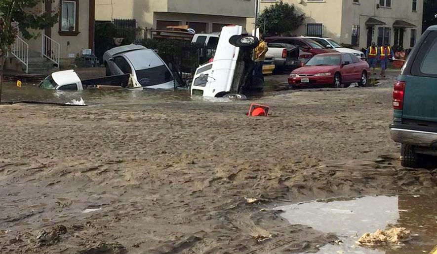 This photo provided by nbc4 shows vehicles that have fallen into a sinkhole on a street flooded by a predawn rupture of a water main in a Los Angeles neighborhood, forcing residents to flee their homes and leaving several vehicles submerged Friday, Dec. 21, 2018. Fire and utility crews were sent to the area, where water flowed for hours. About 40 people were evacuated, the Los Angeles Department of Water and Power said. At one point, a woman fell into an unseen hole after stepping into the water during the evacuation. (Fabian Rodriguez/nbc4 via AP)