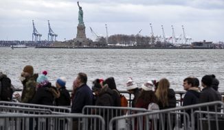 People line up to board a ferry to visit the Statue of Liberty Saturday, Dec. 22, 2018, in New York. The national landmark remained open despite a partial government shutdown after New York Governor Andrew Cuomo made funding available to keep the monument open. (AP Photo/Craig Ruttle)
