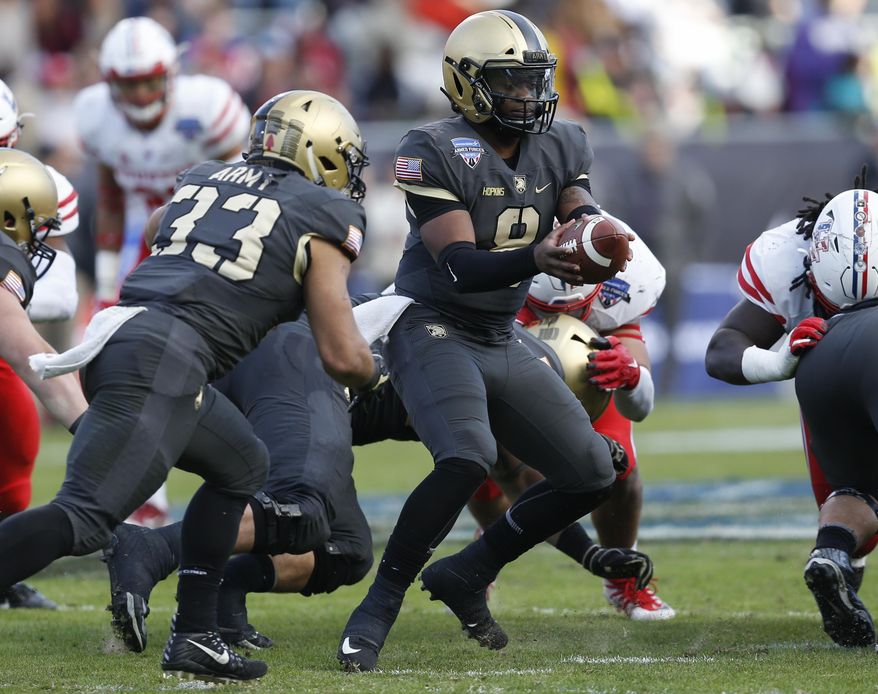 Army quarterback Kelvin Hopkins Jr. (8) prepares to hand off the ball to running back Darnell Woolfolk (33) during the first half of Armed Forces Bowl NCAA college football game against Houston, Saturday, Dec. 22, 2018, in Fort Worth, Texas. (AP Photo/Jim Cowsert)