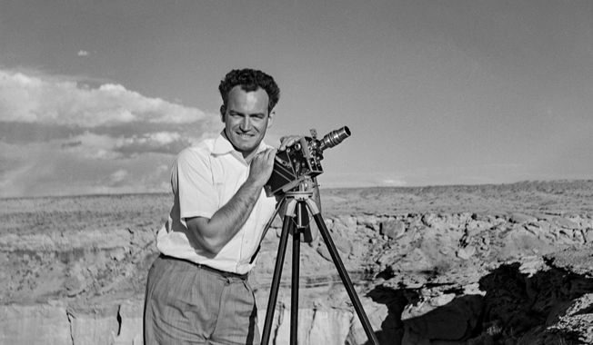In this photograph taken in 1935 by Peggy Goldwater, entitled &amp;quot;Portrait of the Artist as a Married Man,&amp;quot; Barry Goldwater smiles and poses with his camera at Coal Mine Canyon between Tuba City and the Third Mesa in northeastern Arizona.  The late Sen. Barry Goldwater’s granddaughter is working to preserve the thousands of images of Arizona landscapes and Native Americans that he created over his lifetime.Twenty years after the Republican icon’s death, Alison Goldwater Ross has formed a foundation to digitize and repair the images. (AP Photo/Peggy Goldwater/Courtesy of the Barry &amp;amp; Peggy Goldwater Foundation)