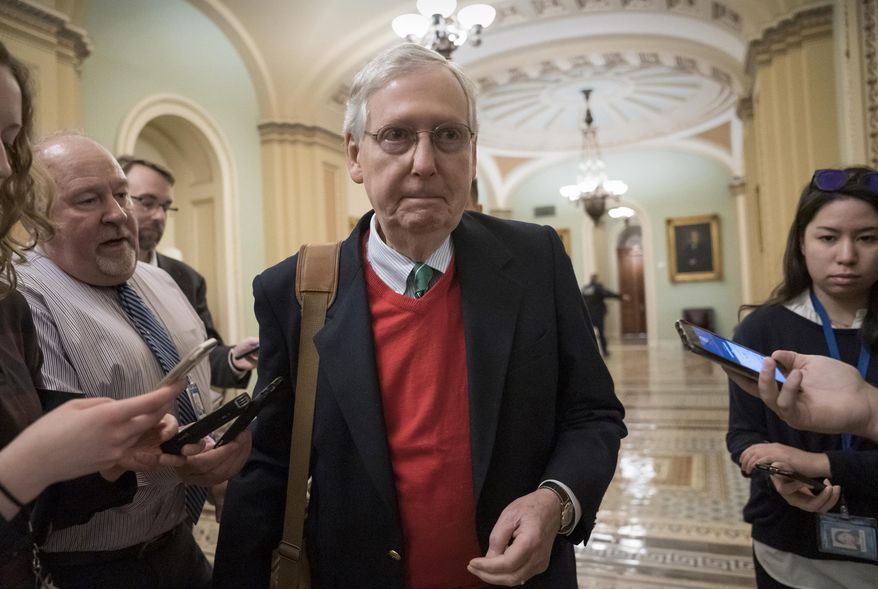 Senate Majority Leader Mitch McConnell, R-Ky., is met by reporters as he arrives at the Capitol on the first morning of a partial government shutdown, as Democratic lawmakers, and some Republicans, are at odds with President Donald Trump on spending for his border wall, in Washington, Saturday, Dec. 22, 2018. (AP Photo/J. Scott Applewhite)