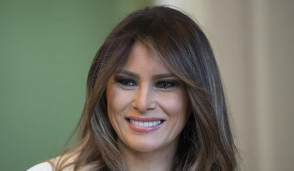 In this Monday, Nov. 27, 2017, file photo, first lady Melania Trump smiles as she visits with children in the East Room of the White House in Washington. (AP Photo/Carolyn Kaster, File)
