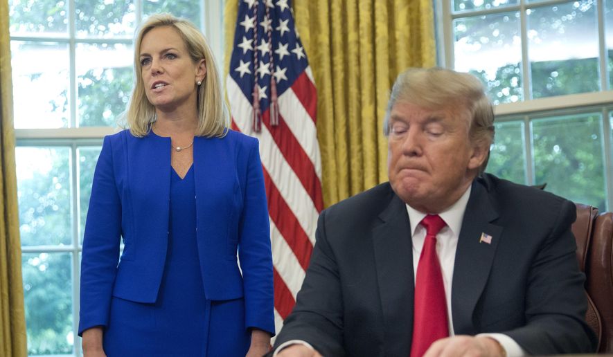 In this June 20, 2018, file photo, President Donald Trump, right, listens as Homeland Security Secretary Kirstjen Nielsen, left, addresses members of the media before Trump signs an executive order to end family separations at the border, during an event in the Oval Office of the White House in Washington. (AP Photo/Pablo Martinez Monsivais, File)