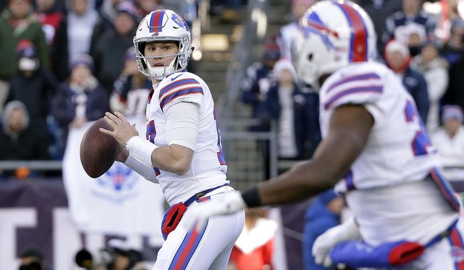 Buffalo Bills quarterback Josh Allen, left, prepares to pass to running back LeSean McCoy, right, during the first half of an NFL football game against the New England Patriots, Sunday, Dec. 23, 2018, in Foxborough, Mass. (AP Photo/Steven Senne)