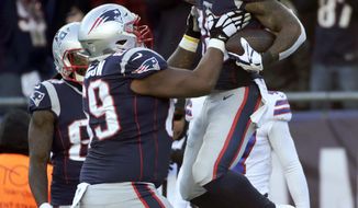 New England Patriots running back James White, right, celebrates his touchdown run with lineman Shaq Mason during the first half of an NFL football game against the Buffalo Bills, Sunday, Dec. 23, 2018, in Foxborough, Mass. (AP Photo/Elise Amendola)