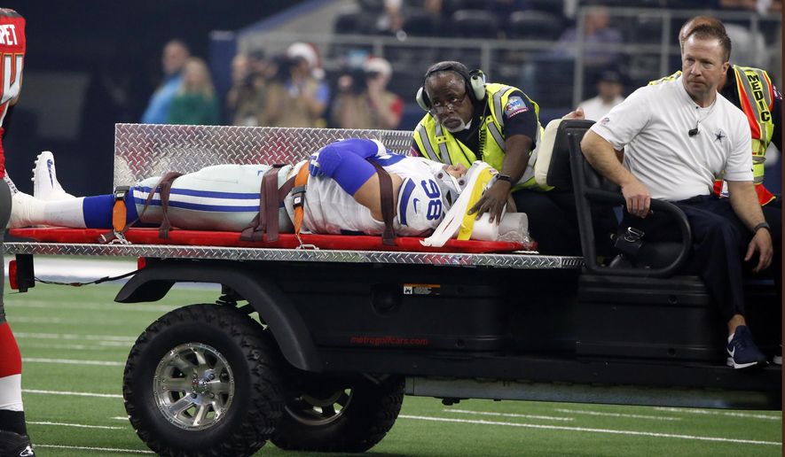 Dallas Cowboys defensive end Tyrone Crawford (98) is carted off the field after suffering an unknown injury in the first half of an NFL football game against the Tampa Bay Buccaneers in Arlington, Texas, Sunday, Dec. 23, 2018. (AP Photo/Michael Ainsworth)