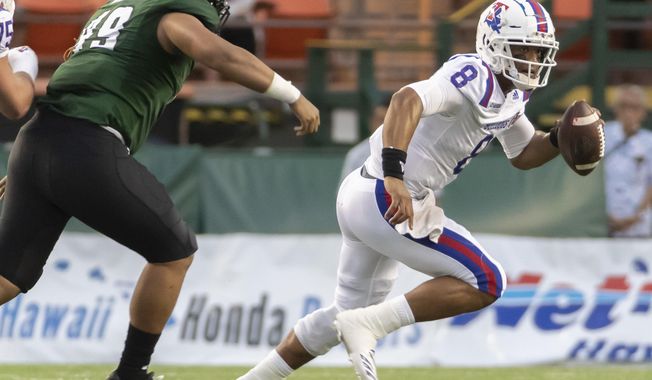 Hawaii defensive lineman Manly Williams (49) attempts to chase down Louisiana Tech quarterback J'Mar Smith (8) in the first half of the Hawaii Bowl NCAA college football game, Saturday, Dec. 22, 2018, in Honolulu. (AP Photo/Eugene Tanner)